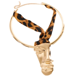 Detailed view of fashionable leopard print ribbon choker with gold abstract face pendant