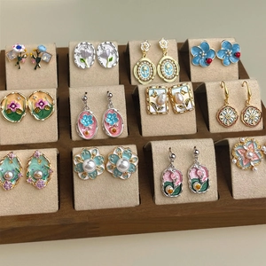 Elegant Monet Garden floral enamel and pearl earrings collection in a display tray