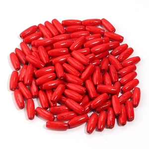 Macro shot of oval red maple wood beads with glossy finish for DIY jewelry making