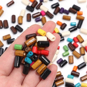 Colorful maple wood cylinder beads for DIY jewelry making shown in hand display