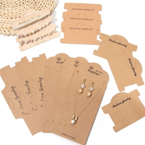 Brown kraft paper display cards for jewelry including necklaces, bracelets, and earrings