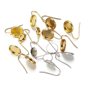 Detailed view of stainless steel earring hooks with round bezel trays in gold and silver