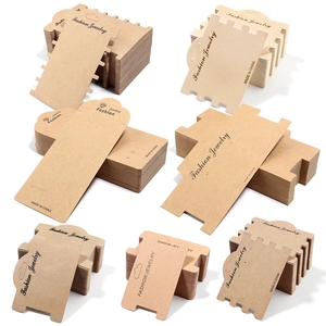 Macro detail of various Kraft paper jewelry display cards for necklaces and earrings