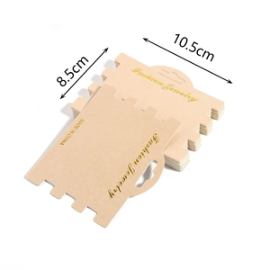 Detail view of brown kraft paper display cards for necklaces with gold lettering and slots