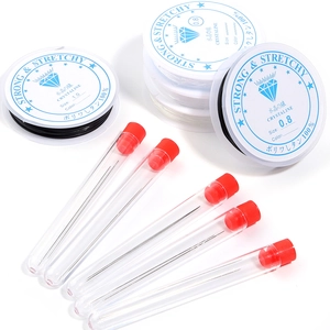 DIY jewelry beading tool set with elastic crystal strings and metal needles on white background