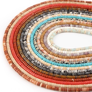 Macro shot of colorful Heishi stone beads showing smooth texture and diverse natural patterns