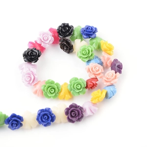 Macro shot of 3D resin camellia flower beads in various colors for DIY jewelry making