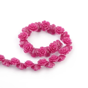 Macro detail of rose red camellia beads with 3D resin floral textures for DIY jewelry