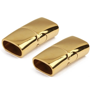 Detailed view of two polished gold magnetic clasps for leather cord jewelry DIY projects
