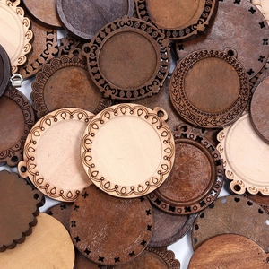Macro view of assorted 25/30mm wooden jewelry tray bases with laser-cut lace edges