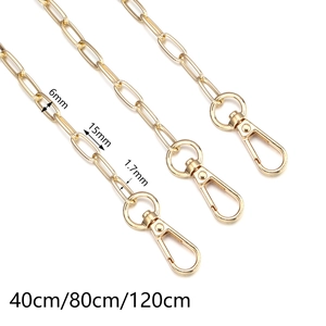 Detailed view of golden diagonal twill paperclip chain with 15x6mm links and lobster clasp