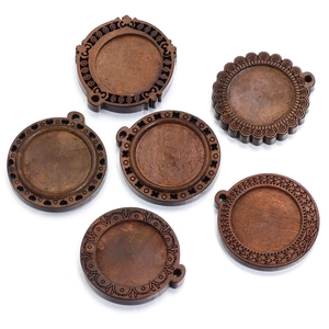 Detailed view of six vintage round wooden pendant trays with diverse floral carved borders