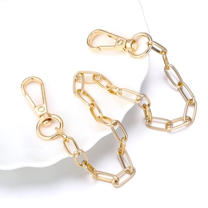Macro view of golden twill square rings chain with lobster clasps and textured links