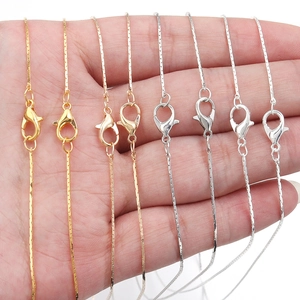 Detailed view of gold, rose gold and silver plated copper chain necklaces with lobster clasps