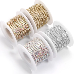 Close-up of four-claw rhinestone chain rolls in multiple colors for DIY jewelry crafts