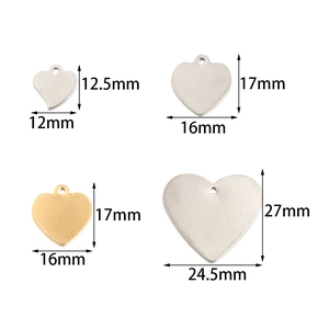 Detailed view of heart-shaped stainless steel pendants in various sizes and gold silver tones