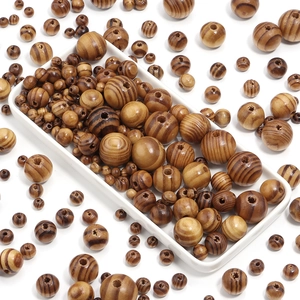 Macro shot of striped natural pine wood beads in various sizes for DIY crafts