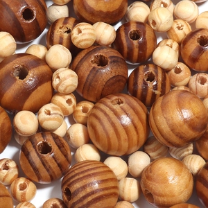 Macro detail of striped pine wood beads in various sizes for DIY jewelry making