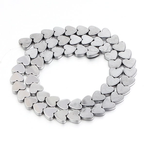 Macro detail of dark silver hematite heart-shaped beads for DIY jewelry making