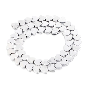 Close-up of polished silver heart-shaped hematite beads for DIY jewelry making