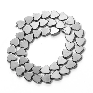 Macro shot of metallic heart-shaped hematite beads for DIY jewelry making accessories