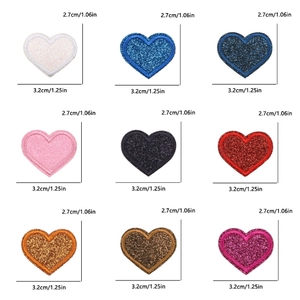 Macro display showing nine colors of glitter heart embroidery patches with dimensions