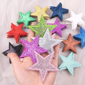 Close-up of colorful glitter star patches with embroidery for clothes and bag decoration