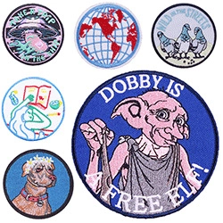 Macro detail of various embroidered patches including Van Gogh starry night and movie characters