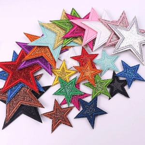 Detailed close-up of colorful glitter star embroidered patches for clothing and DIY decor