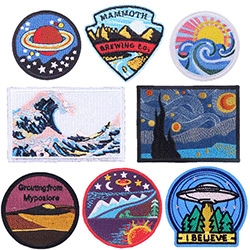 Detailed close-up of mixed embroidered patches featuring space and nature themes