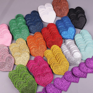 Close-up of colorful glitter heart embroidery patches for clothing and DIY accessories