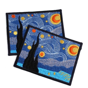 Macro detail of Starry Night embroidered patches with high-density stitching and black borders