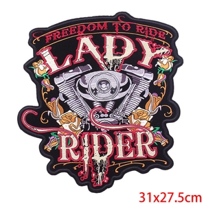 Macro view of Freedom to Ride embroidery patch with engine and yellow roses on black twill