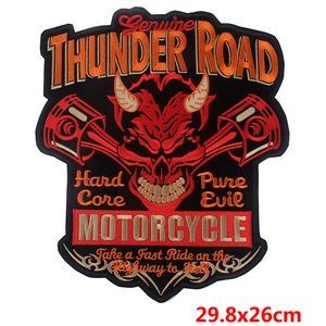 Macro detail of large punk skull embroidery patch with Thunder Road cross pistons