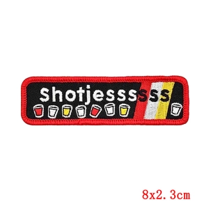 Close-up of black embroidered patch with red border and shotjessssss text in 8x2.3cm