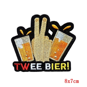 Detail of Twee Bier embroidered patch with hand sign and beer mugs for Carnival