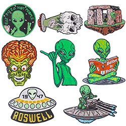 Detailed view of punk sci-fi embroidered patches with Roswell UFO and alien designs