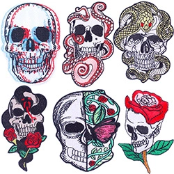 Detailed view of six gothic skull patches with embroidered snakes and red roses