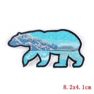 Polar bear embroidered patch featuring a snow mountain landscape design for DIY apparel