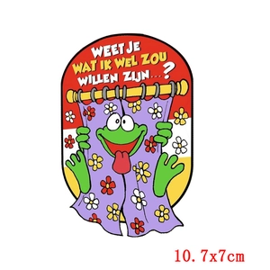 Detail showing cartoon frog embroidery patch with Dutch text and 10.7x7cm dimensions