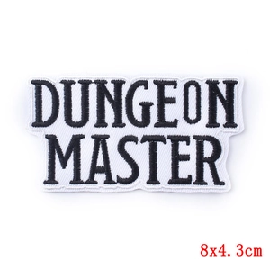 Detail of Dungeon Master embroidered patch with bold text and 8x4.3cm dimensions