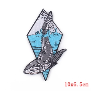 Diamond frame whale embroidery patch showing whale jumping out of water 10x6.5cm