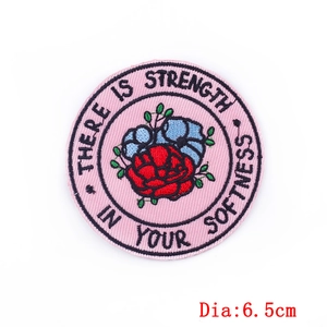 Pink round embroidery patch with red rose and 'There is strength in your softness' slogan