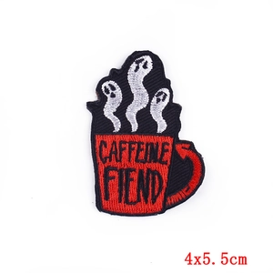 Close-up of 4x5.5cm Caffeine Fiend embroidered patch with red mug and ghost steam motifs