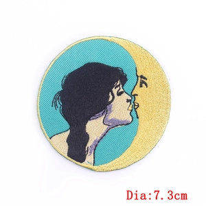 Embroidered 7.3cm patch featuring an artistic woman kissing a golden moon on peacock blue
