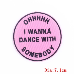 Pink circular embroidered feminist patch with black lettering and 7.1cm diameter size