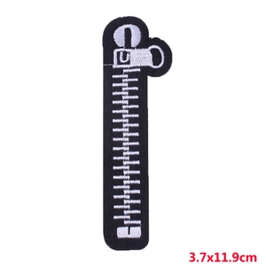 Detailed macro view of black zipper-shaped embroidery patch with white U-logo