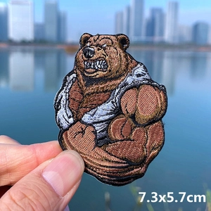 Detailed embroidered muscle bear patch measuring 7.3x5.7cm for denim and DIY clothing