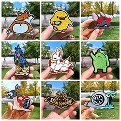Detailed close-up of nine cartoon animal embroidery patches on a green outdoor background