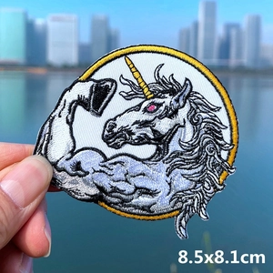 Detail of embroidered muscular unicorn patch with size markings for DIY clothing